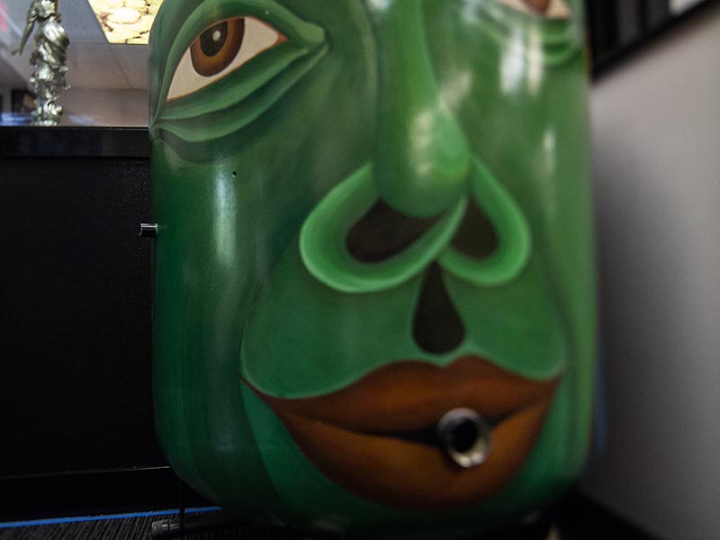 Click to view Rachel Laundon website. Image by Laundon of green face painted on small brew tank.