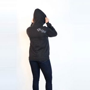 Female modeling charcoal grey zip Heady Topper hoodie. Back shows stylized Heady Topper text. Back view.