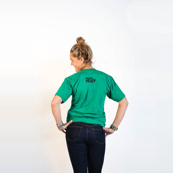 Female modeling green tee with Heady Topper logo. Back design is in black and reads "Ready For a Heady?"