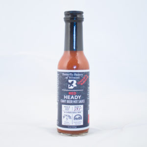 Five ounce red hot sauce bottle with black label.