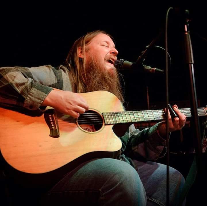 Seth Yacovone playing acoustic guitar